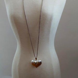 Beautiful sterling heart shaped pendant with gold tone floral design.